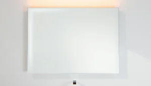 Admire an elegant bathroom mirror with integrated lighting, enhancing modern bathroom aesthetics.